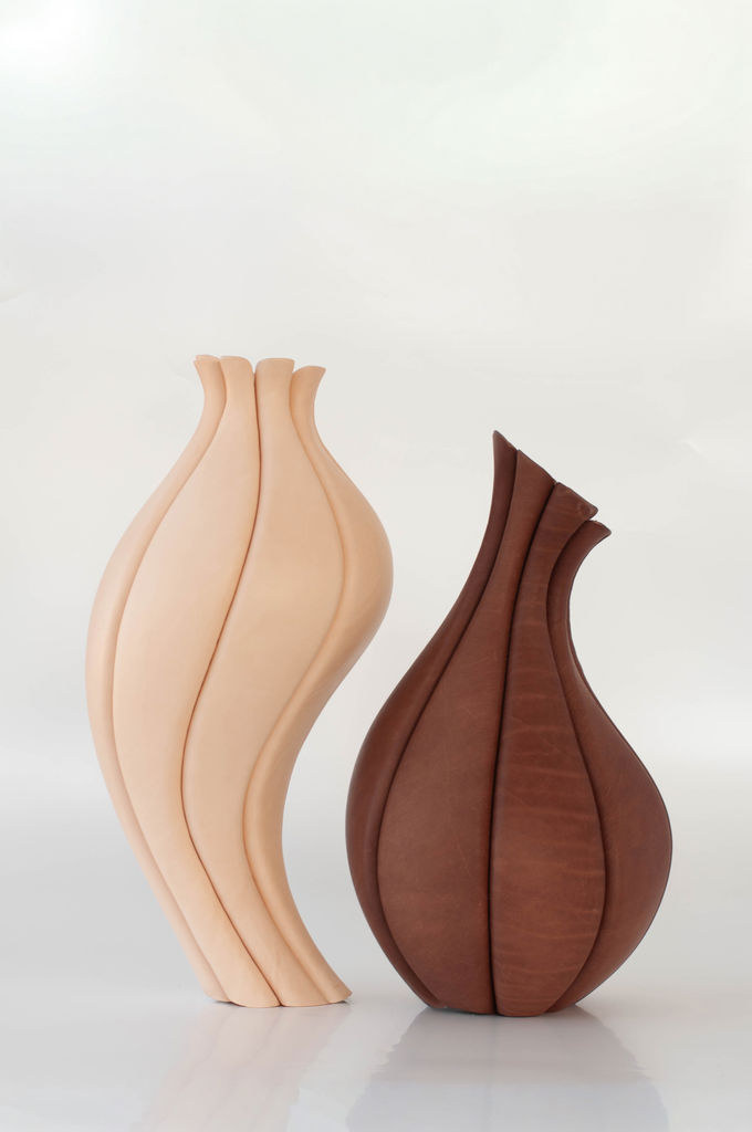 TRACE by Talia Luvaton, two handcrafted sculptural leather vessels in light and dark vegetable-tanned leather, photographed against a clean white background.